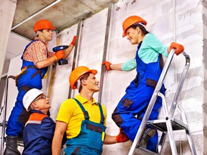 Group people in builder uniform.