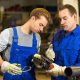 instructor teaches trainee how to use an angle grinder